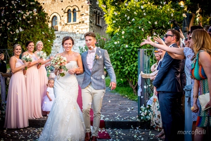 Petals shower the newlyweds upon exiting the Palazzo Duchi di Santo Stefano in Taormina